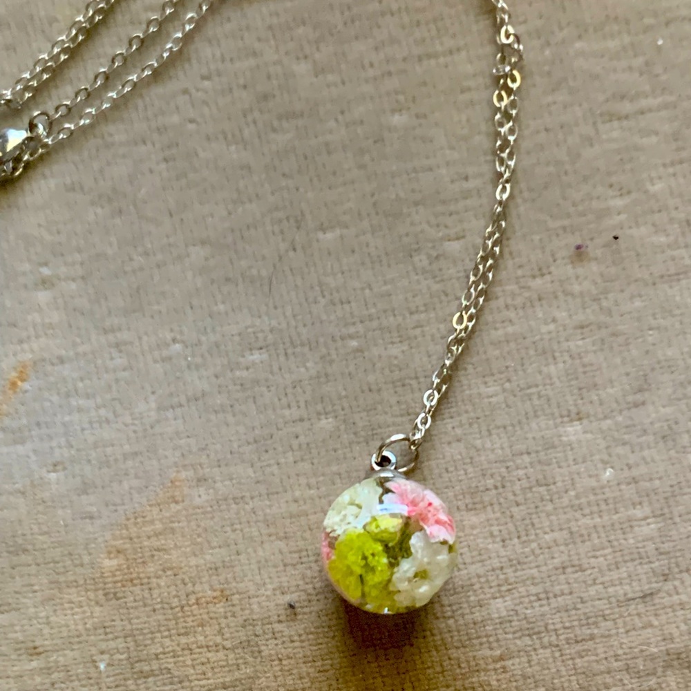Beautiful handcrafted pressed flowers in a glass necklace.